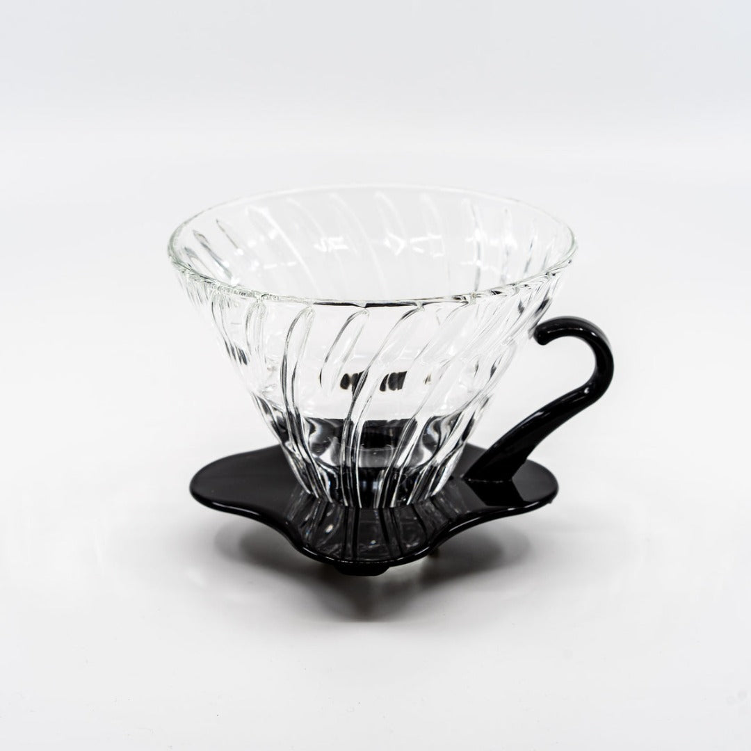 Hario V60 white ceramic brewer in cafe setting.