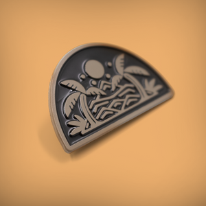 Close up of enamel pin showing an island with mountains and palm trees.