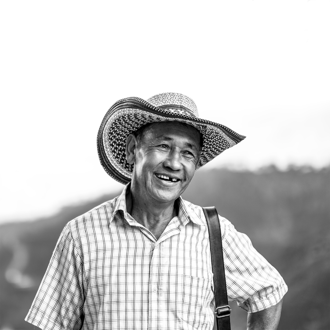 Enamel Pin depicting a coffee farmer.